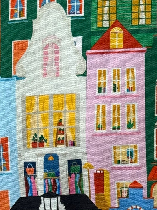 Close-up of the Amsterdam Canal tote bag print hanging on a wall beside a vintage rotary phone