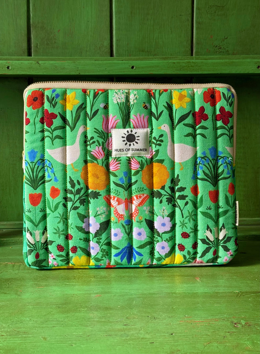 Garden Reverie quilted tablet sleeve with green floral duck print, front view