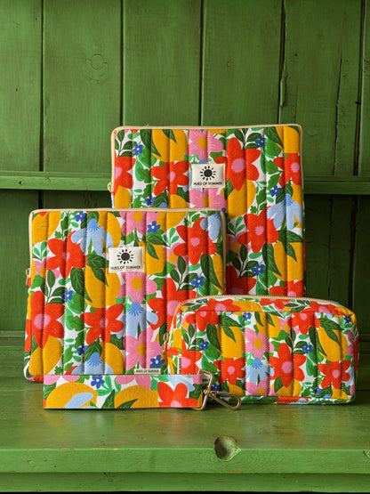 Citrus Bloom quilted laptop sleeve shown in three sizes stacked together