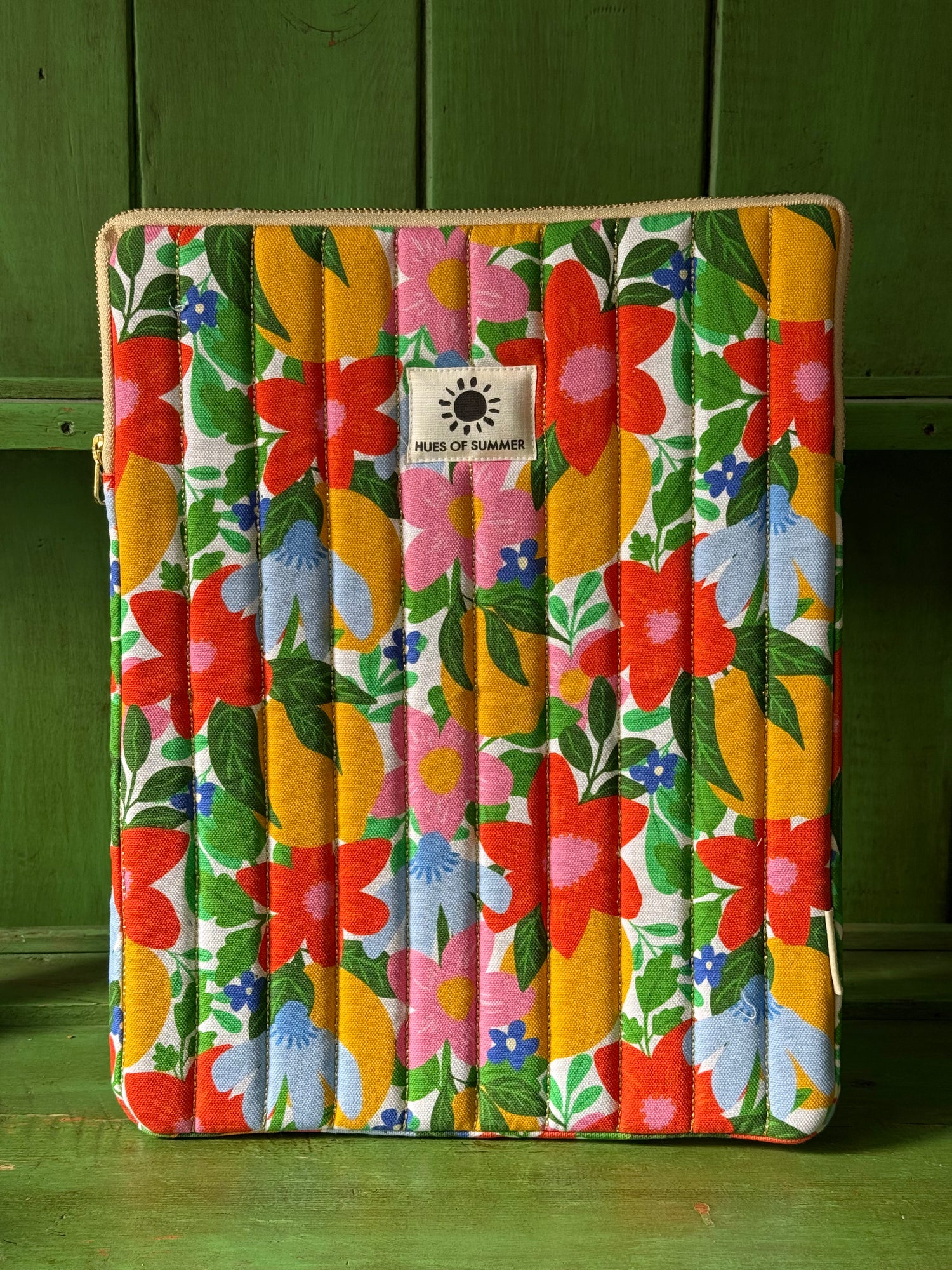 Citrus Bloom quilted laptop sleeve with floral print, front view standing upright