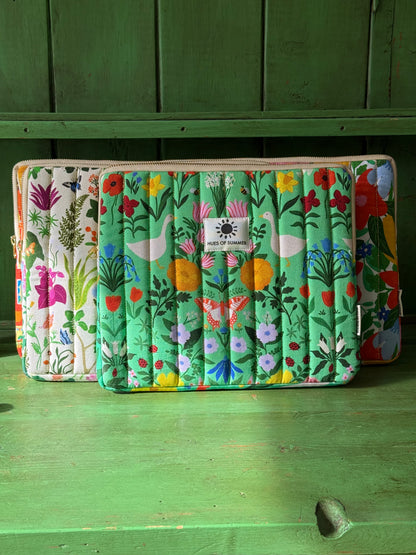 Garden Reverie tablet sleeve displayed with two other floral quilted sleeves