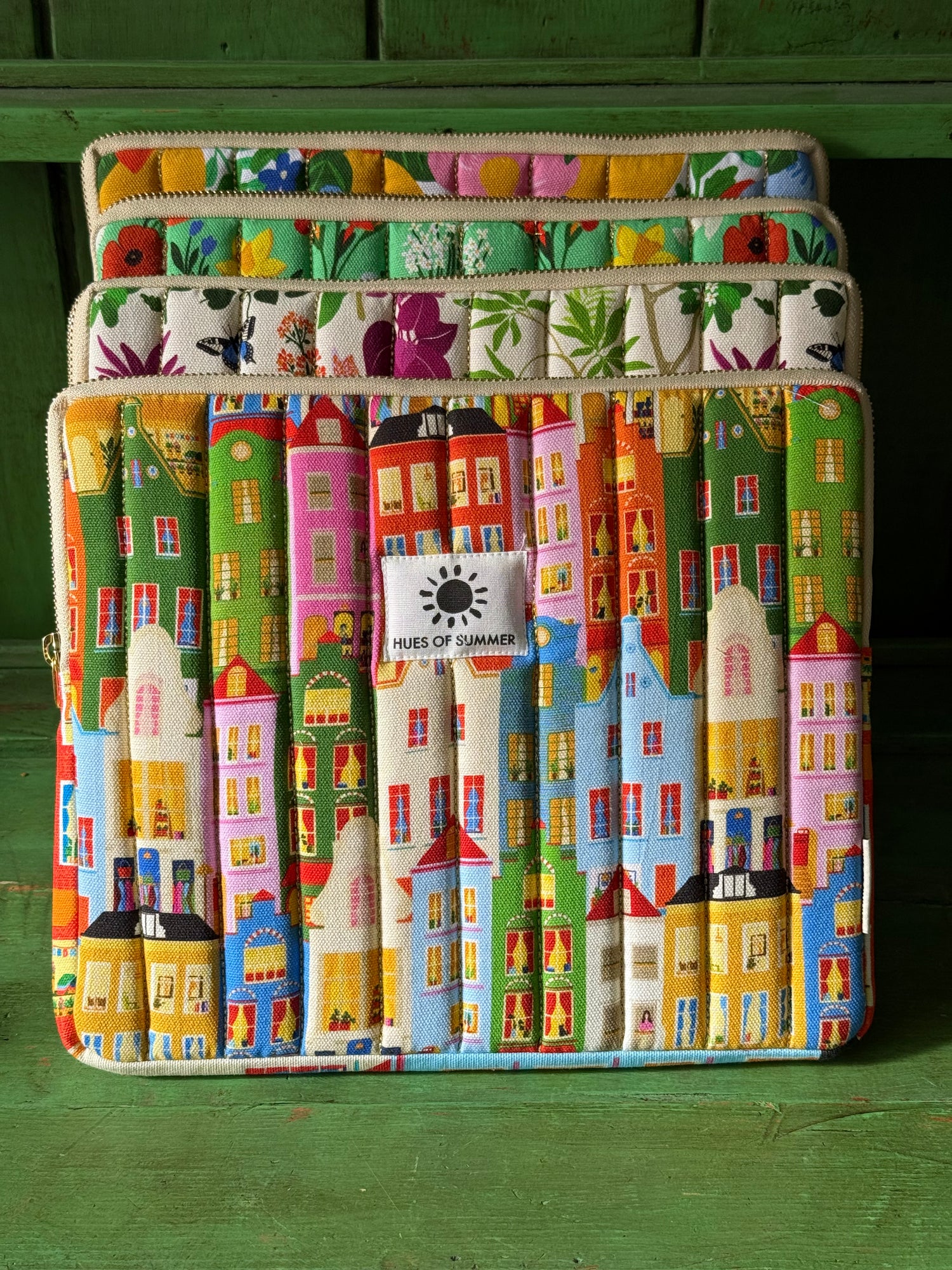 Amsterdam tablet sleeve stacked with three other floral quilted sleeves