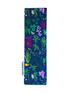 A rectangular fabric bookmark with a colorful botanical print on a navy blue background, laid flat on a light brown wooden surface. A small white fabric tag on the left side reads &