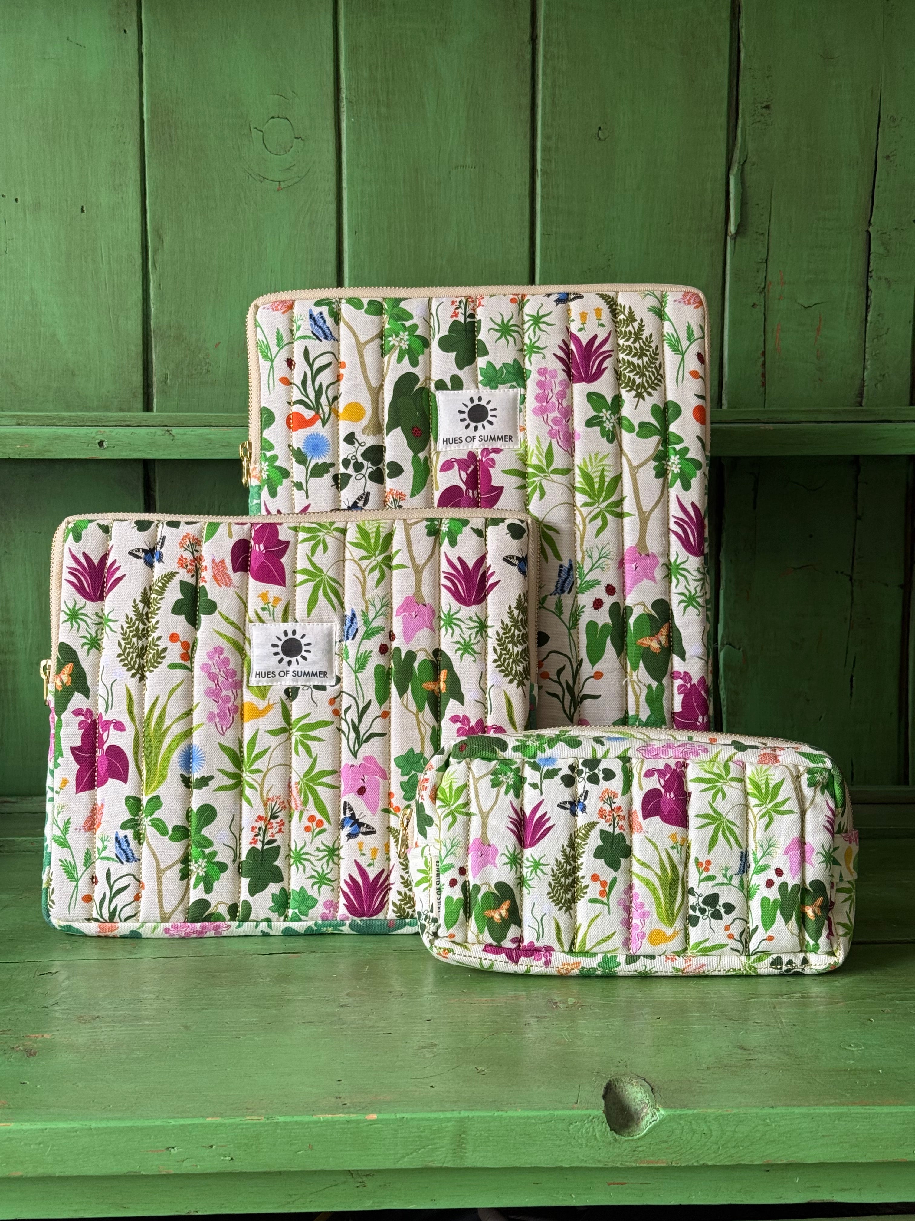 Bugs and Bloom tablet sleeve, laptop sleeve, and cosmetic pouch grouped together