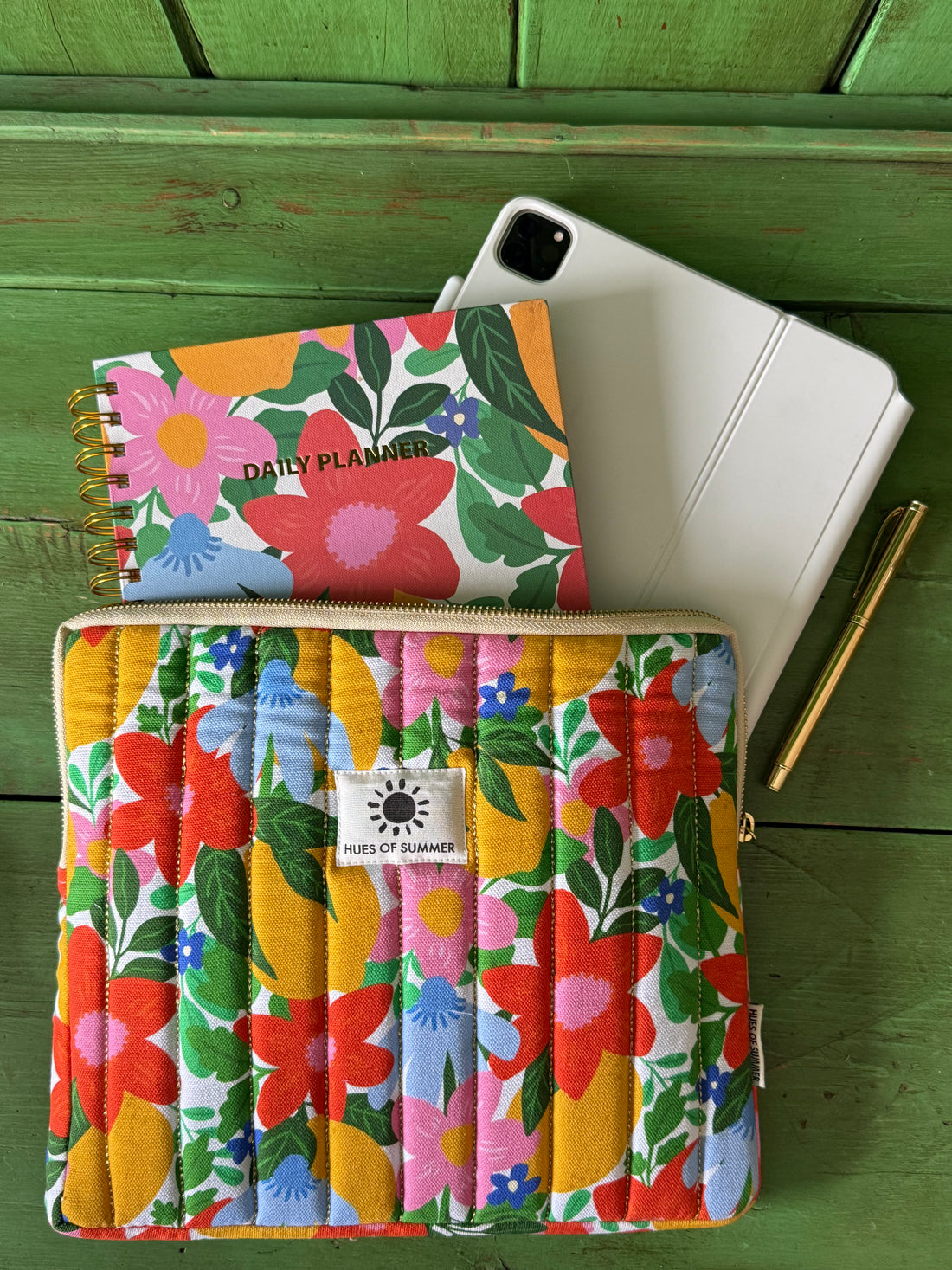 Citrus Blooms quilted tablet sleeve with a matching daily planner, tablet, and pen