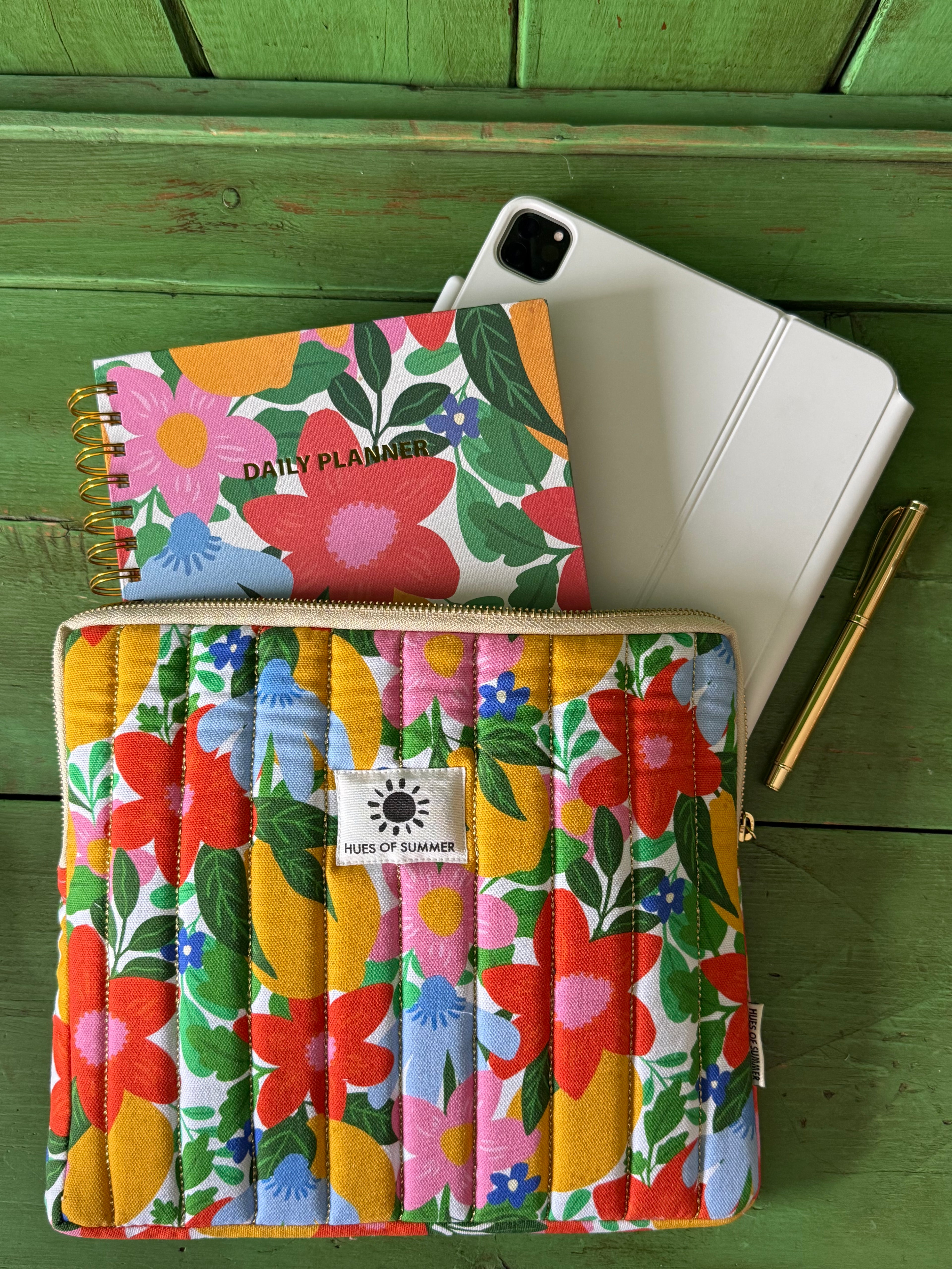 Citrus Blooms quilted tablet sleeve with a matching daily planner, tablet, and pen