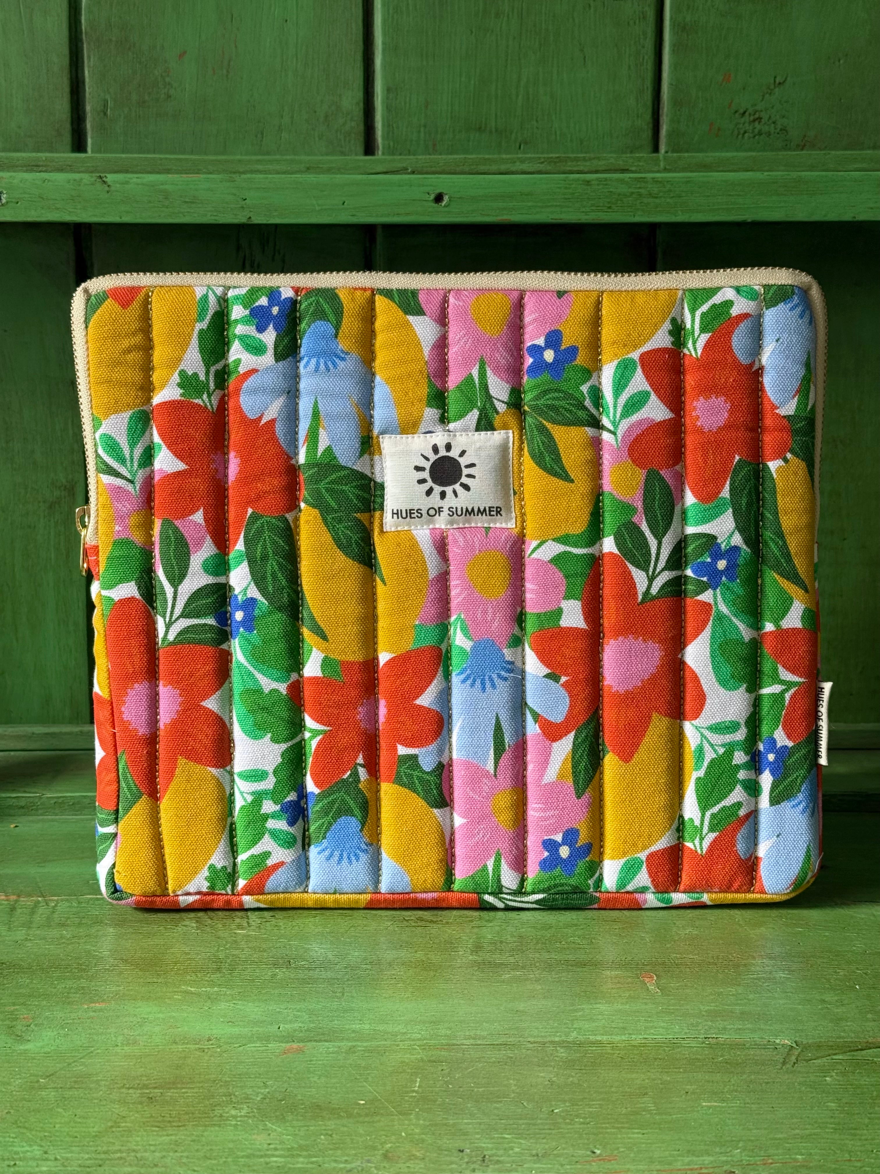 Citrus Blooms quilted tablet sleeve, front view showing floral gold-quilted design
