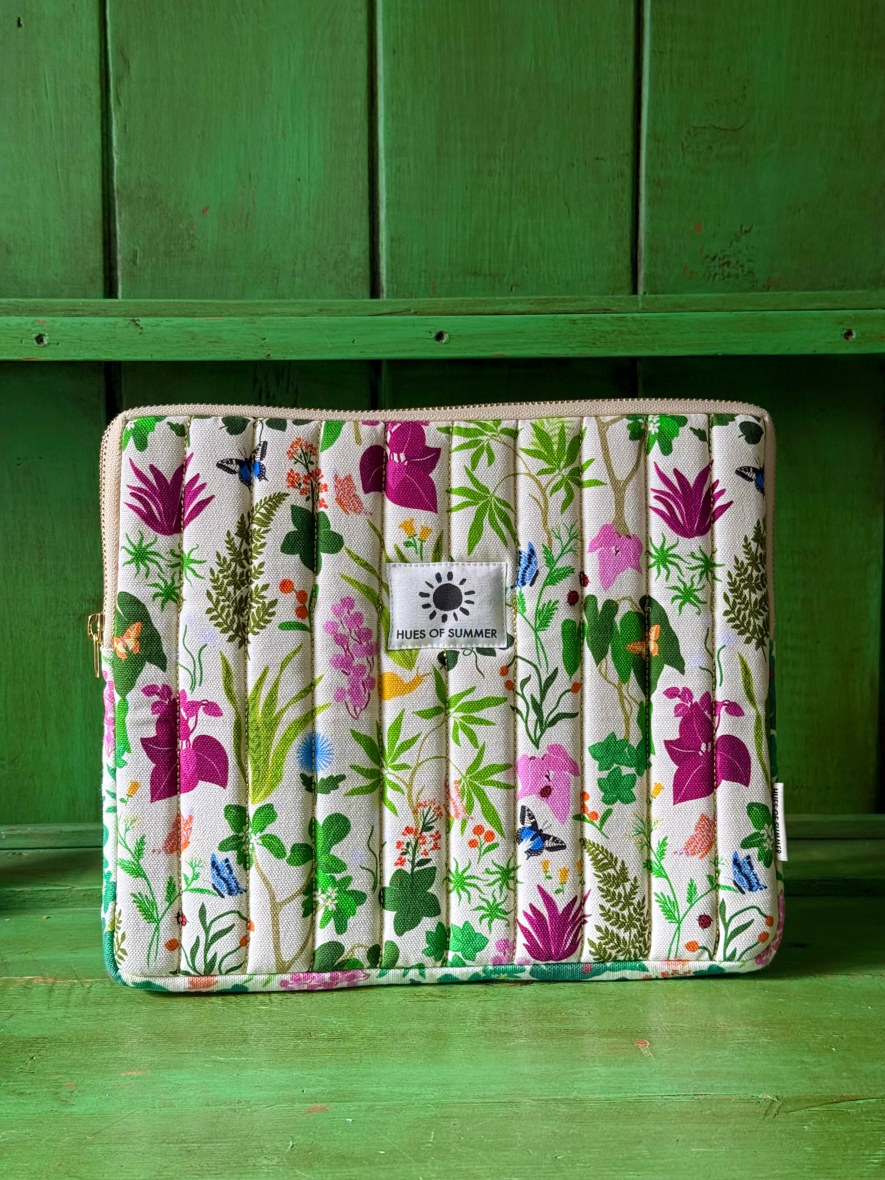 Ivory Bugs and Bloom quilted tablet sleeve with botanical print, front view