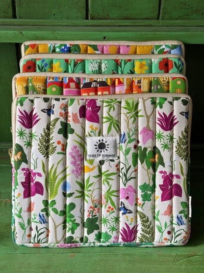 Ivory Bugs and Bloom tablet sleeve stacked with three other quilted sleeve designs